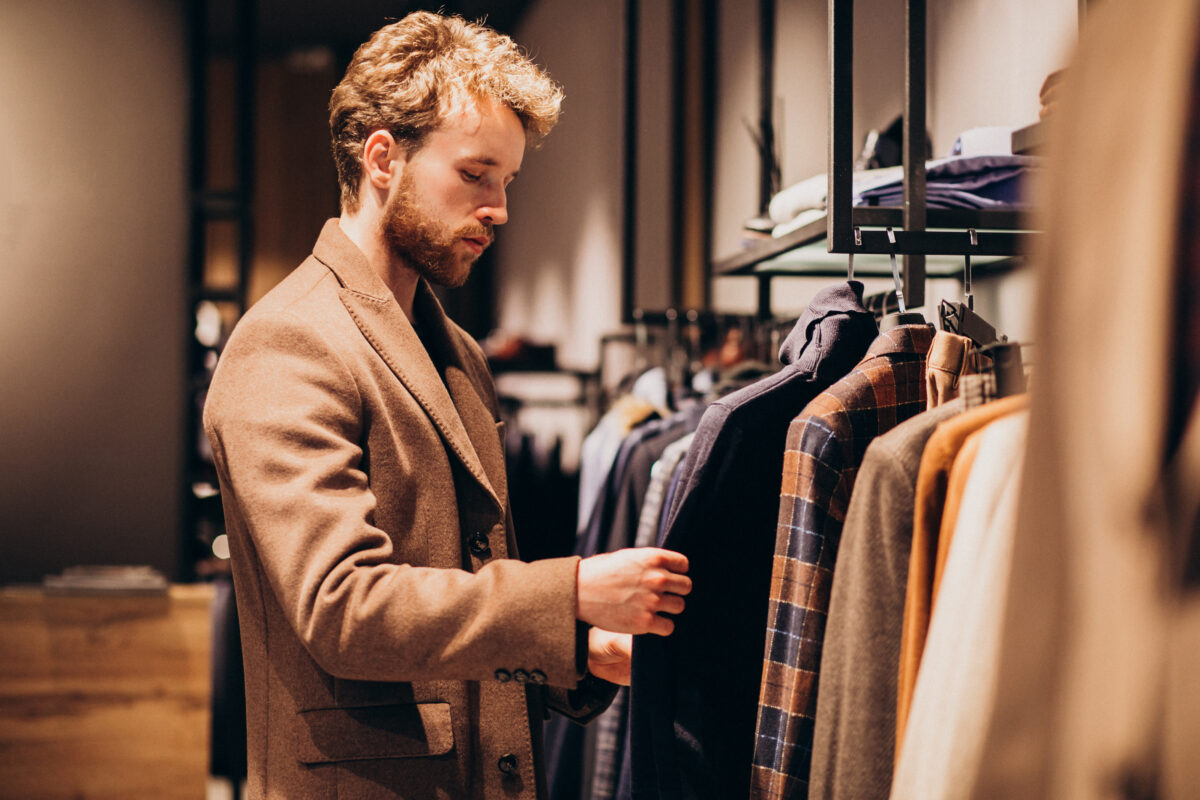 Picture shows a man choosing apparels